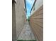 Narrow side yard featuring gravel, a gate, and pavers, designed for practical use and easy maintenance at 8105 Switchback Run St, Las Vegas, NV 89166