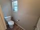 Neutral-toned powder room/toilet room with wood look flooring and a window at 8105 Switchback Run St, Las Vegas, NV 89166