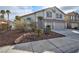 Charming two-story home featuring a two car garage, well kept landscaping, and a red tile roof at 8305 Woodland Prairie Ave, Las Vegas, NV 89129