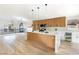 Bright kitchen with pendant lighting, stainless steel appliances, and a large island with a marble countertop at 8305 Woodland Prairie Ave, Las Vegas, NV 89129