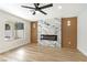 Living room with wood floors, marble fireplace, and natural light at 8305 Woodland Prairie Ave, Las Vegas, NV 89129