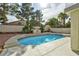 Backyard pool with surrounding landscaping and trees at 8305 Woodland Prairie Ave, Las Vegas, NV 89129