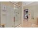 Bathroom featuring a sleek glass-enclosed shower with white tile surround and a handheld shower head at 8324 W Charleston Blvd # 2053, Las Vegas, NV 89117