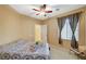 Neutral bedroom with ceiling fan, carpet flooring, and a window at 8324 W Charleston Blvd # 2053, Las Vegas, NV 89117