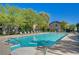 Large community pool with lounge chairs and a covered table area at 8324 W Charleston Blvd # 2053, Las Vegas, NV 89117