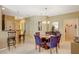 Cozy dining area with chandelier and bar seating to kitchen area at 8324 W Charleston Blvd # 2053, Las Vegas, NV 89117
