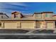 Townhouse complex showcasing garages and tiled roofs against a blue sky at 8324 W Charleston Blvd # 2053, Las Vegas, NV 89117
