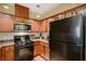 Well-equipped kitchen with dark appliances and wood cabinetry at 8324 W Charleston Blvd # 2053, Las Vegas, NV 89117