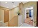 Upper landing with natural decor leading into sunlit bedroom with hardwood floors at 8324 W Charleston Blvd # 2053, Las Vegas, NV 89117