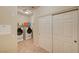 Convenient laundry room with modern washer and dryer, storage shelf, and sliding closet doors at 8324 W Charleston Blvd # 2053, Las Vegas, NV 89117