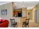 Open-concept kitchen featuring bar seating and view into living room at 8324 W Charleston Blvd # 2053, Las Vegas, NV 89117