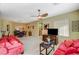 Open-concept living room with plush sofas, ceiling fan, and combined dining area at 8324 W Charleston Blvd # 2053, Las Vegas, NV 89117