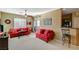 Comfortable living room featuring plush red sofas and adjacent breakfast bar at 8324 W Charleston Blvd # 2053, Las Vegas, NV 89117