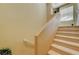 Carpeted stairway features neutral walls and railing to a window-lit landing at 8324 W Charleston Blvd # 2053, Las Vegas, NV 89117