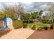 Expansive backyard featuring a lush lawn, vibrant landscaping, and a storage shed for outdoor essentials at 8346 Christinas Cove Ave, Las Vegas, NV 89131