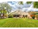 Expansive backyard with a covered patio, mature trees, and well-maintained lawn, offering a serene outdoor retreat at 8346 Christinas Cove Ave, Las Vegas, NV 89131