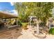 Picturesque backyard featuring mature trees, gravel landscaping, and shaded patio areas perfect for outdoor living and entertaining at 8346 Christinas Cove Ave, Las Vegas, NV 89131