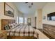 Spacious bedroom with a rustic wood frame bed, and an ensuite bathroom entrance at 8346 Christinas Cove Ave, Las Vegas, NV 89131