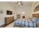 Cozy bedroom with a ceiling fan, a rustic dresser, and dark wood flooring and a fluffy rug at 8346 Christinas Cove Ave, Las Vegas, NV 89131