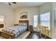 Charming bedroom with a rustic wood frame bed, a yellow desk, and bright natural lighting at 8346 Christinas Cove Ave, Las Vegas, NV 89131