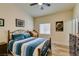 Comfortable bedroom with a unique light fixture, wood-look floors, and decor at 8346 Christinas Cove Ave, Las Vegas, NV 89131