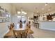 Elegant dining area featuring a chandelier, tile flooring, and seamless flow to the kitchen at 8346 Christinas Cove Ave, Las Vegas, NV 89131