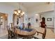 Charming dining room with a chandelier, dining table, and views into other rooms, creating an inviting atmosphere at 8346 Christinas Cove Ave, Las Vegas, NV 89131