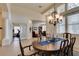 Elegant dining room featuring a chandelier, large windows, and access to other living spaces, perfect for hosting gatherings at 8346 Christinas Cove Ave, Las Vegas, NV 89131