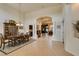 Elegant formal dining room with neutral walls, tile flooring, and decorative pillars at 8346 Christinas Cove Ave, Las Vegas, NV 89131