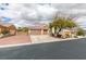 Attractive home with a tile roof, three-car garage, desert landscaping, and gated RV parking at 8346 Christinas Cove Ave, Las Vegas, NV 89131