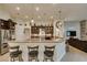 Modern kitchen with dark wood cabinetry, stainless steel appliances, and granite countertops at 8346 Christinas Cove Ave, Las Vegas, NV 89131