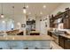 Gourmet kitchen with stainless steel appliances, a center island, and seamless flow to the adjacent living spaces at 8346 Christinas Cove Ave, Las Vegas, NV 89131
