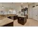 Large gourmet kitchen with an island, stainless steel appliances, dark cabinets, and granite countertops at 8346 Christinas Cove Ave, Las Vegas, NV 89131