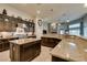 Modern kitchen with granite countertops, dark wood cabinets, a central island, and high-end appliances at 8346 Christinas Cove Ave, Las Vegas, NV 89131