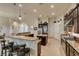 Well-equipped kitchen featuring dark cabinets, granite countertops, an island, and ample counter space at 8346 Christinas Cove Ave, Las Vegas, NV 89131