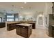 Open kitchen layout with island, dark cabinets, granite counters, and stainless appliances at 8346 Christinas Cove Ave, Las Vegas, NV 89131