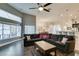 Spacious living room with dark wood floors, ceiling fan, and large windows providing ample natural light at 8346 Christinas Cove Ave, Las Vegas, NV 89131