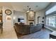 Cozy living room with stone fireplace, wood floors, fan, and large windows overlooking the yard at 8346 Christinas Cove Ave, Las Vegas, NV 89131