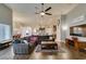 Open-concept living room featuring wood floors, a ceiling fan, and a large comfortable sectional sofa at 8346 Christinas Cove Ave, Las Vegas, NV 89131