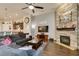 Inviting living room with stone fireplace, wood floors, and open access to the kitchen at 8346 Christinas Cove Ave, Las Vegas, NV 89131