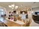 Spacious living area featuring a chandelier, tile floors, and seamless flow to the kitchen at 8346 Christinas Cove Ave, Las Vegas, NV 89131