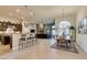 Open-concept living space with a kitchen island, fireplace, breakfast nook, and access to the patio at 8346 Christinas Cove Ave, Las Vegas, NV 89131