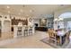 Open-concept living space with tile floors, breakfast bar, modern lighting, and comfortable seating at 8346 Christinas Cove Ave, Las Vegas, NV 89131