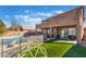 Backyard featuring a large pool with a diving board and an artificial grass area at 8817 Adobe Grande St, Las Vegas, NV 89131