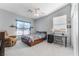 Bright bedroom with light grey walls, ceiling fan, white trim and a window with blinds at 8817 Adobe Grande St, Las Vegas, NV 89131