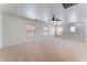 Bright and spacious bonus room with neutral carpet, a ceiling fan, and multiple windows for natural light at 8872 Perfect Diamond Ct, Las Vegas, NV 89129