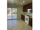 Well-lit kitchen featuring a sliding glass door to a backyard patio at 8872 Perfect Diamond Ct, Las Vegas, NV 89129