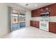 Bright kitchen with wood cabinets and white appliances, including sliding glass door access to backyard at 8872 Perfect Diamond Ct, Las Vegas, NV 89129
