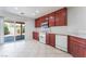 Bright kitchen featuring white appliances, wood cabinets, and a sliding glass door to the patio at 8872 Perfect Diamond Ct, Las Vegas, NV 89129