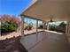 Covered patio area featuring a ceiling fan and views of the landscaped backyard at 8872 Perfect Diamond Ct, Las Vegas, NV 89129
